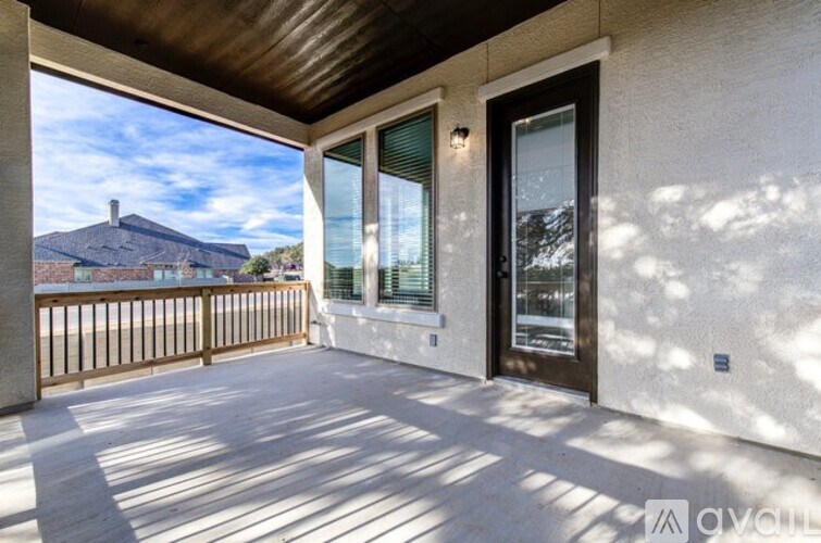A balcony with a view of a mountain and a house.