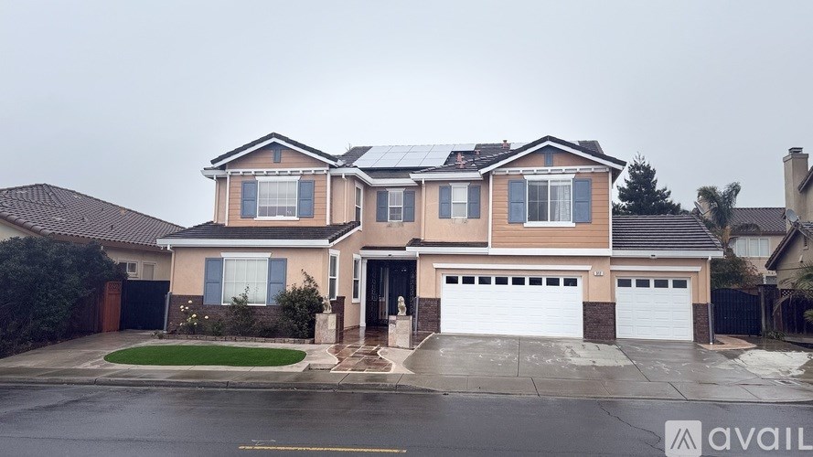A two-story house with a garage is available for sale.