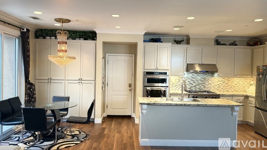 A modern kitchen with a dining table and chairs.