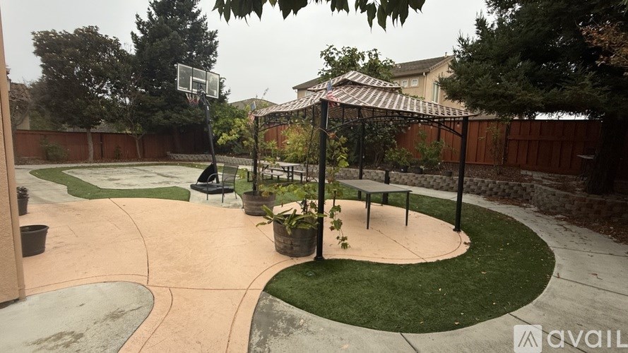 A basketball court with a hoop and a bench.