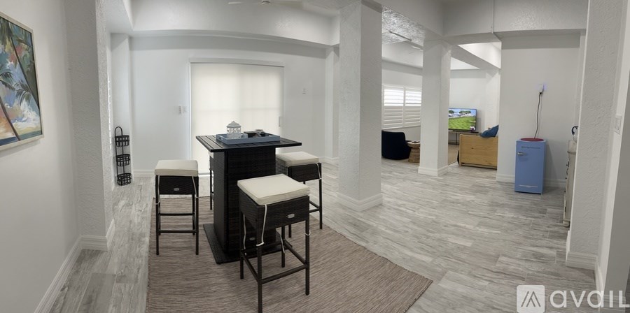 A room with a bar and stools.