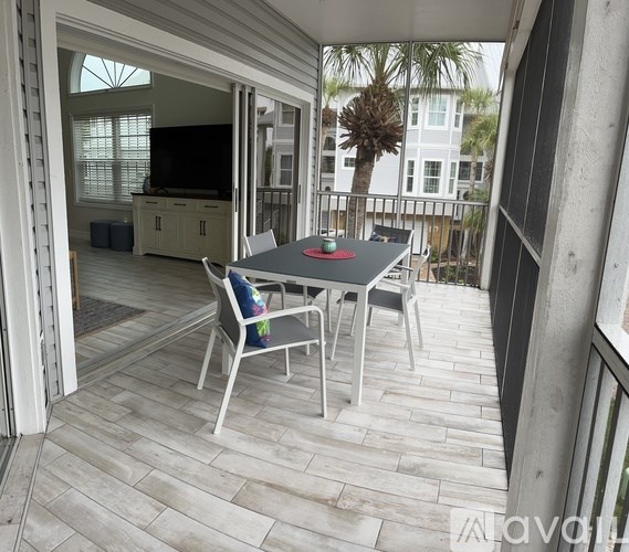A table with chairs is on a balcony.