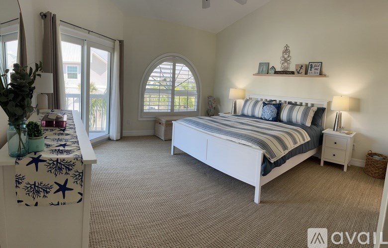 A bedroom with a large bed and a window with a view of the outside.