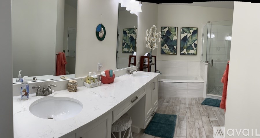 A bathroom with a white sink and a mirror.