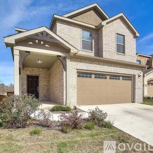 A two-story house with a garage and a covered entryway.