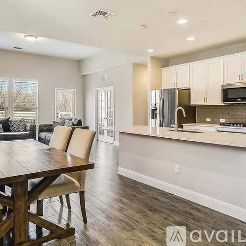 A kitchen with a refrigerator, microwave, and oven is available for rent.