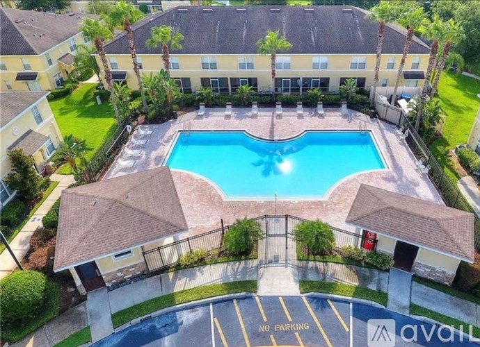 A large building with a pool in front and a no parking sign.