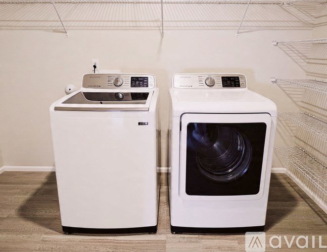 A white washing machine and dryer are sitting next to each other.
