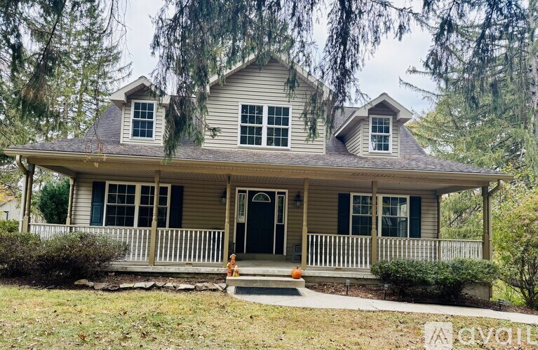 A house with a front porch and a black door.