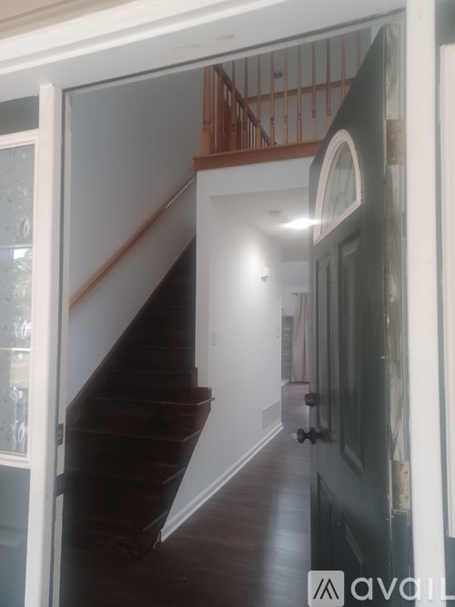 A hallway with a staircase leading to the second floor.