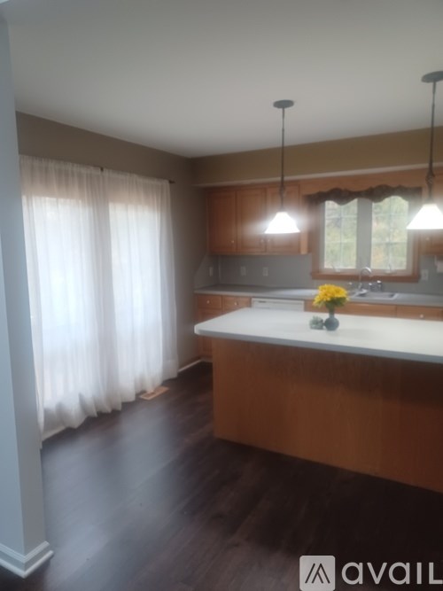 A kitchen with wooden cabinets and a white countertop.