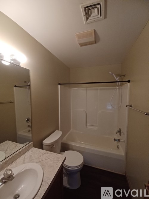A bathroom with a toilet, sink, and bathtub.