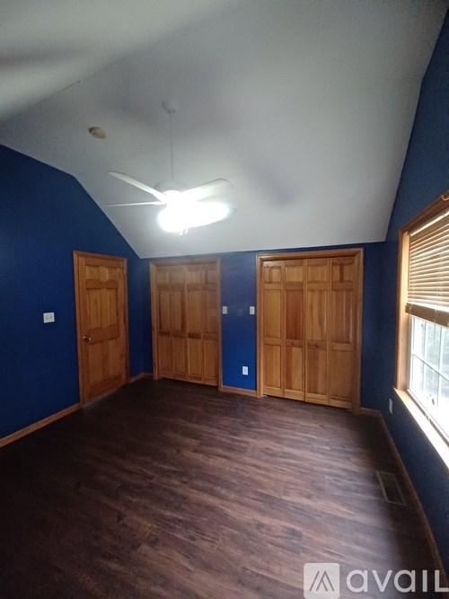 A room with blue walls and wooden doors.