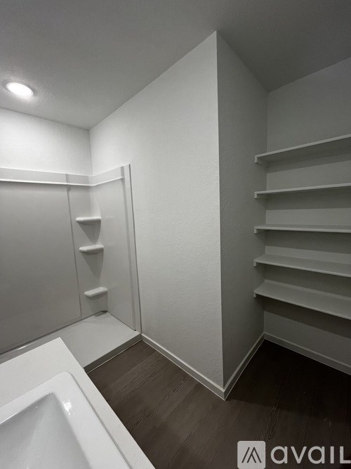 A bathroom with a white sink and a white toilet.