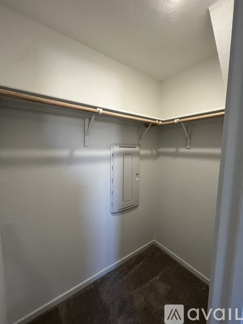 A white wall with a metal pipe and a white door.