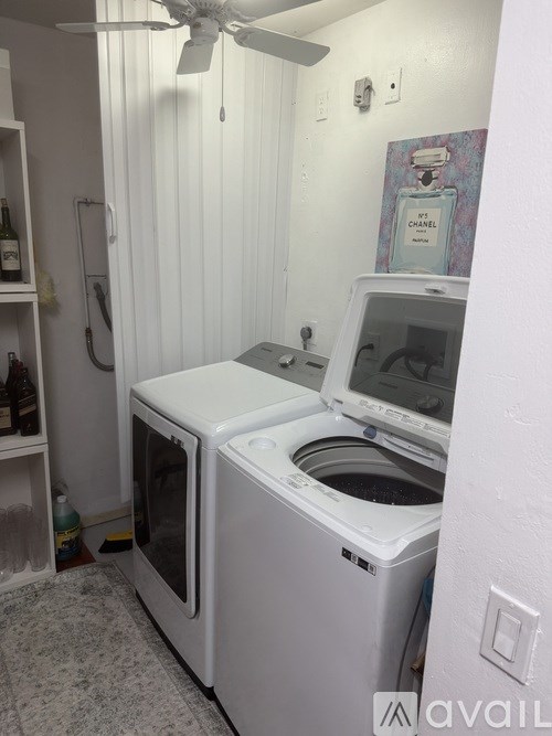 A white washing machine and dryer in a small laundry room.