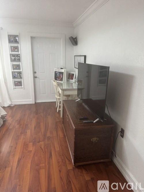 A covered walkway with white pillars and a roof.