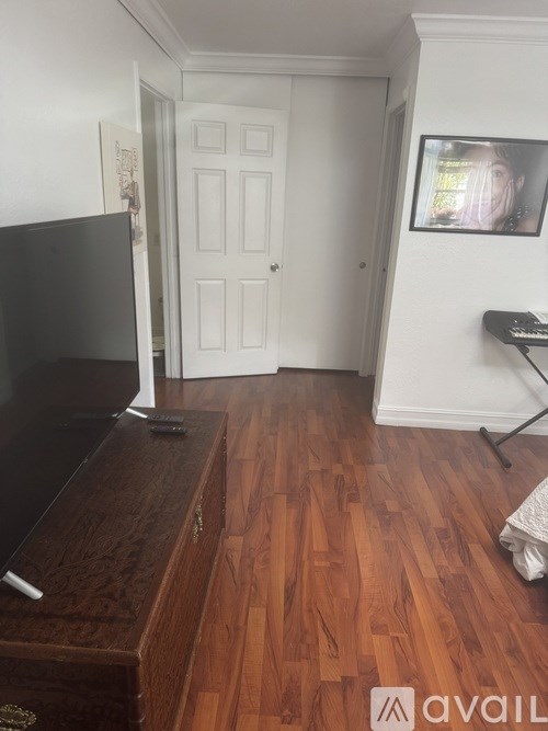 A road with a traffic cone and a building with flags on it.