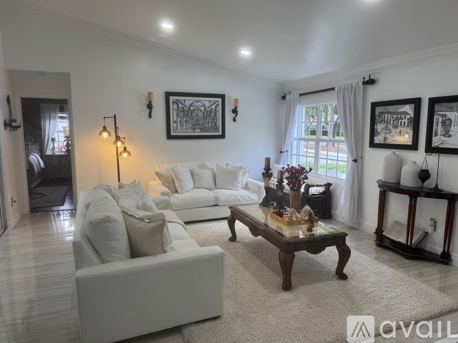 A living room with a white couch and a coffee table.