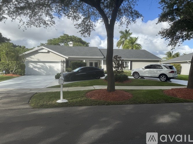 A house with a driveway and a car parked in front.