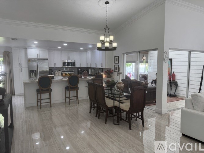 A modern kitchen with a dining table set for four.