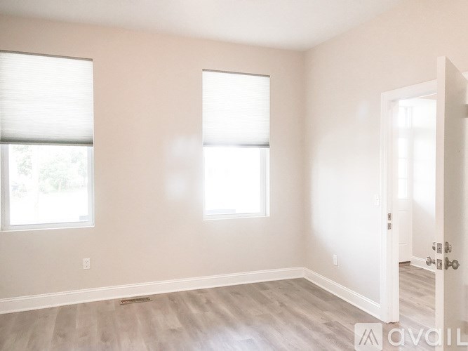 A room with two windows and a door.