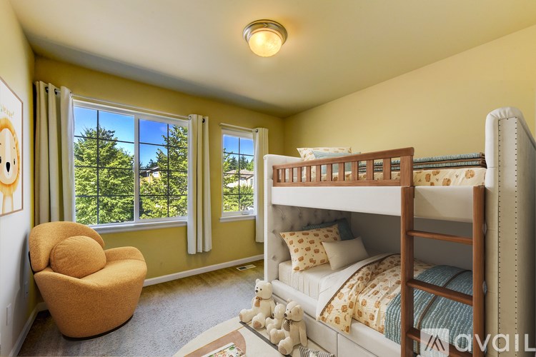 A bedroom with a bunk bed and a chair.