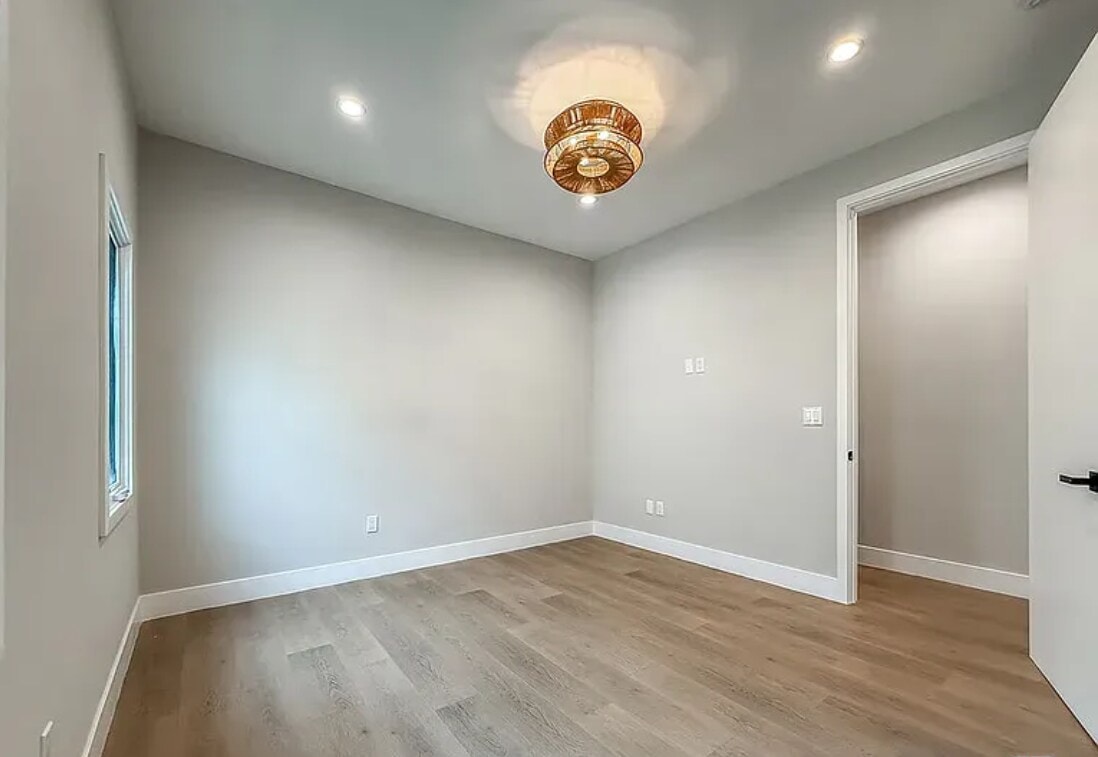 A room with a wooden floor and a ceiling light fixture.