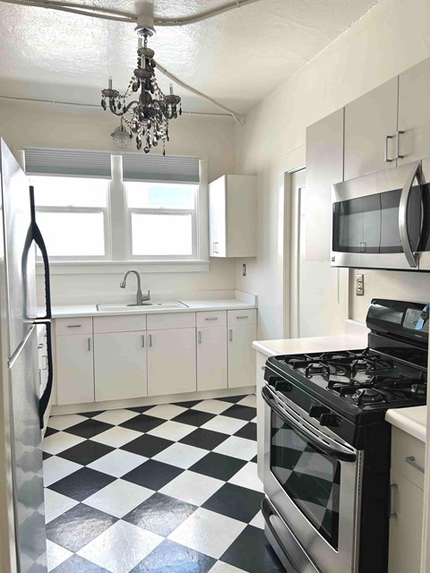 A black and white checkered floor in a kitchen.