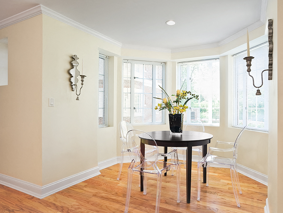 a dining room with a table and chairs and a window