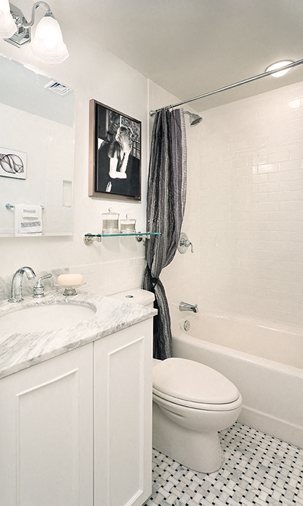 a bathroom with a toilet and a tub and a sink