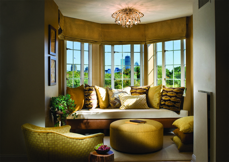 a living room with a window seat and a chandelier