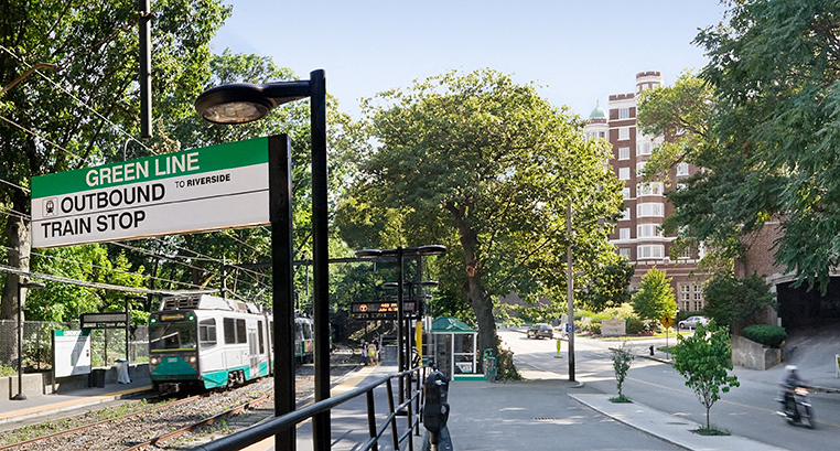 a green line train stop on a city street