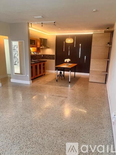 A kitchen with a table and chairs in the middle of the room.