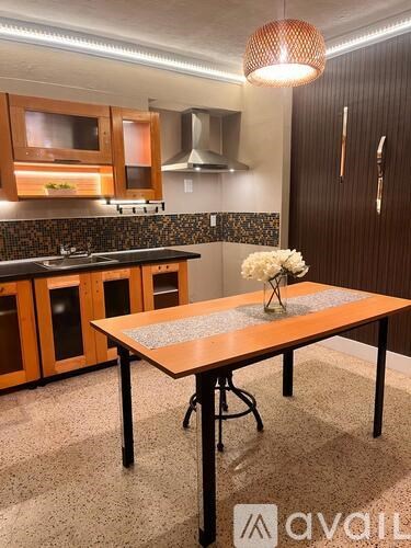 A kitchen with a table and chairs in the foreground.