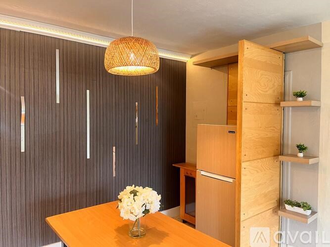 A wooden table with a vase of flowers on it.