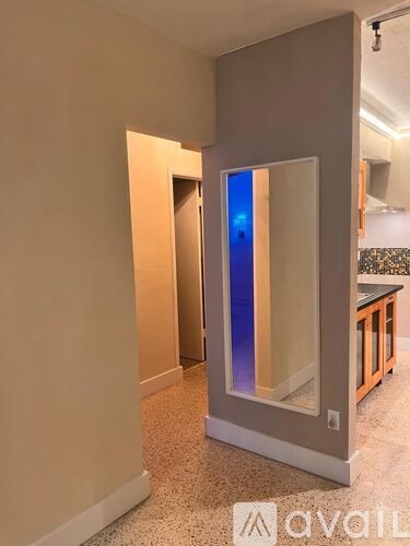 A modern kitchen with a glass door cabinet.