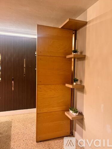 A wooden door with a shelf on the side.