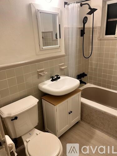 A bathroom with a toilet, sink, and bathtub.