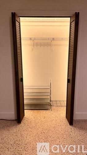 A white room with a ladder and a white wall.