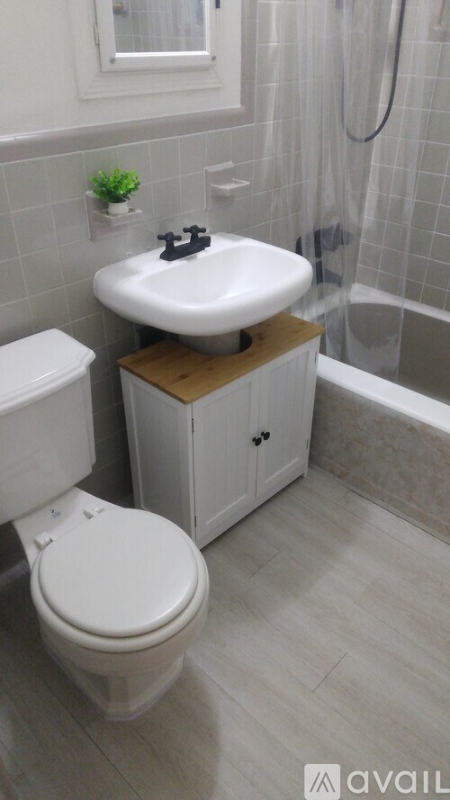 A white toilet sits next to a sink in a bathroom.