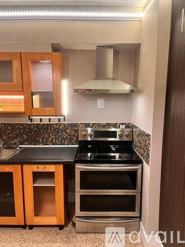 A modern kitchen with a stove top oven and a microwave.