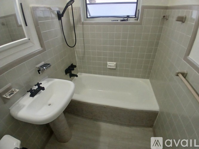 A lamp with a white shade is mounted on a wall.