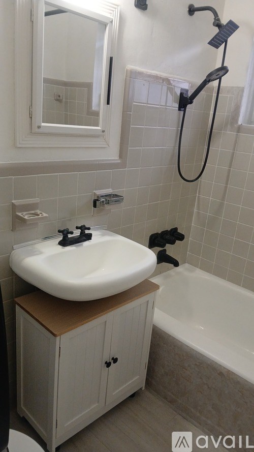 A bathroom with a white sink and a white tub.