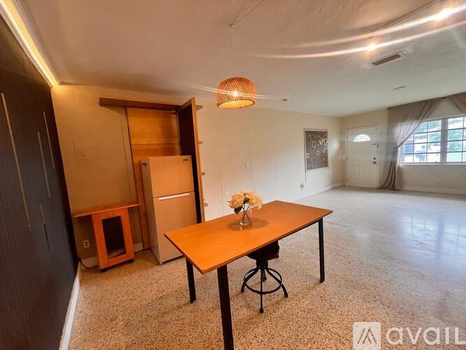 A room with a table and chairs in it.