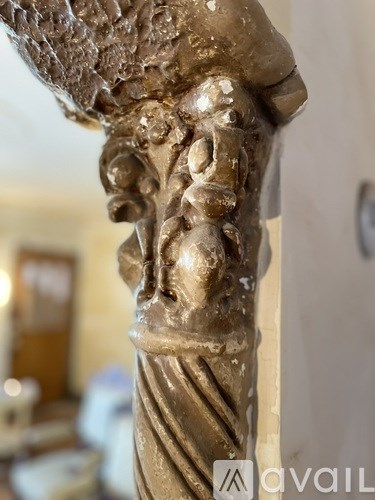 A close up of a golden statue of a face.