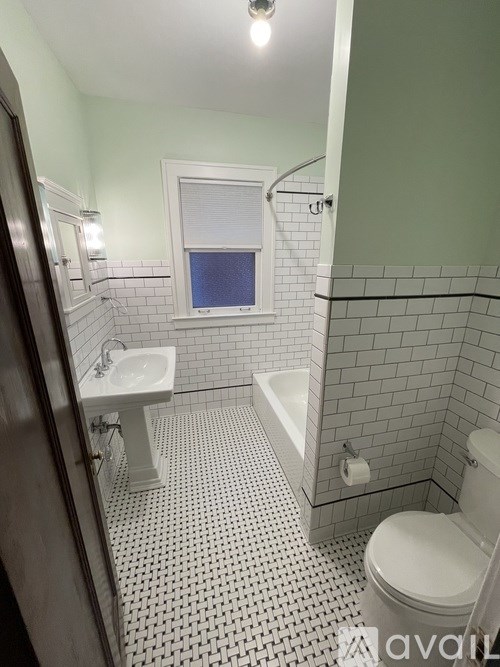 A light bulb is on a wall next to a closet.