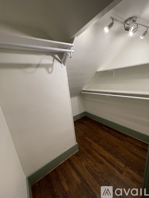 A two-story house with a front porch and a brick facade.