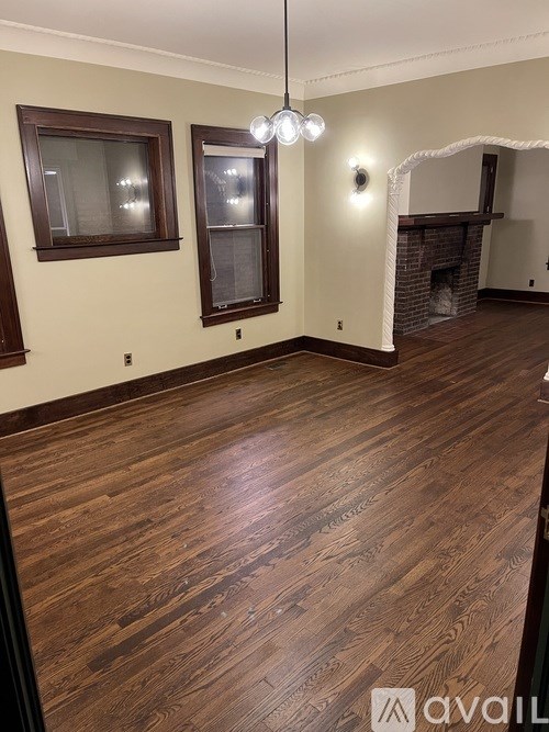 A room with a ceiling fan and a light on the wall.