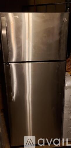 A stainless steel refrigerator with the word "available" written on the floor.